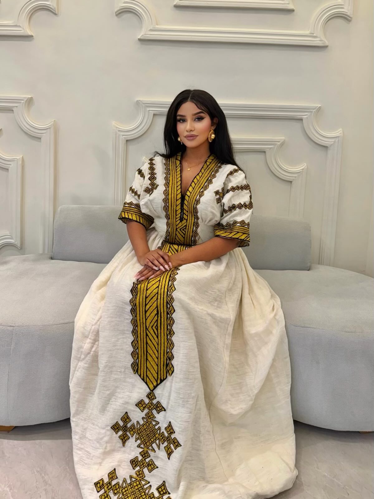 TRADITIONAL HABESHA DRESS WITH GOLDEN EMBROIDERY AND CULTURAL DETAIL ETHIOPIAN HERITAGE STYLE