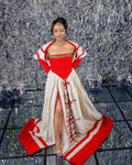 Woman in a red and white outfit with a textured silver background
