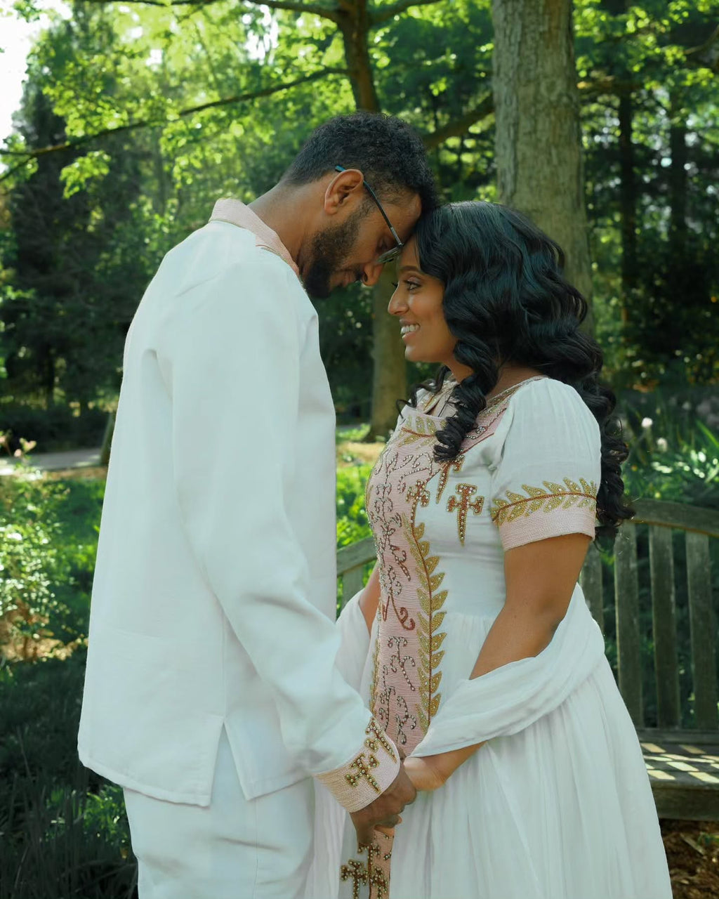 VERONICA ETHIOPIAN WEDDING COUPLE'S OUTFIT | WHITE HABESHA DRESS AND MEN’S SUIT | GOLD AND PINK EMBROIDERY HABESHA COUPLE'S OUTFIT